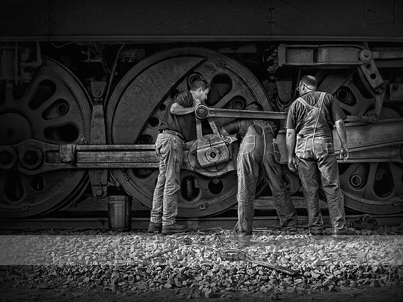 "Here's the Problem" Three men repairing a Steam Engine