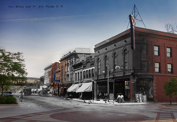 View looking north on Broadway from the intersection with 1st Avenue No., showing the east side of the street. Business signs visible are, W. O. Olsen Furniture, J. Roen & Co. Millinery, and Ideal The