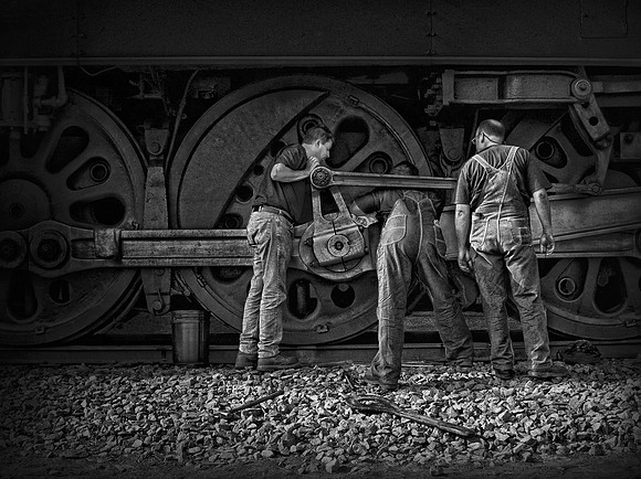 "Here's the Problem" Three men repairing a Steam Engine