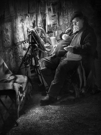 "Social Media Artist" A man checks his phone while waiting for customers